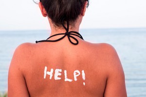 Help written with Sun Cream on a Woman's Shoulder
